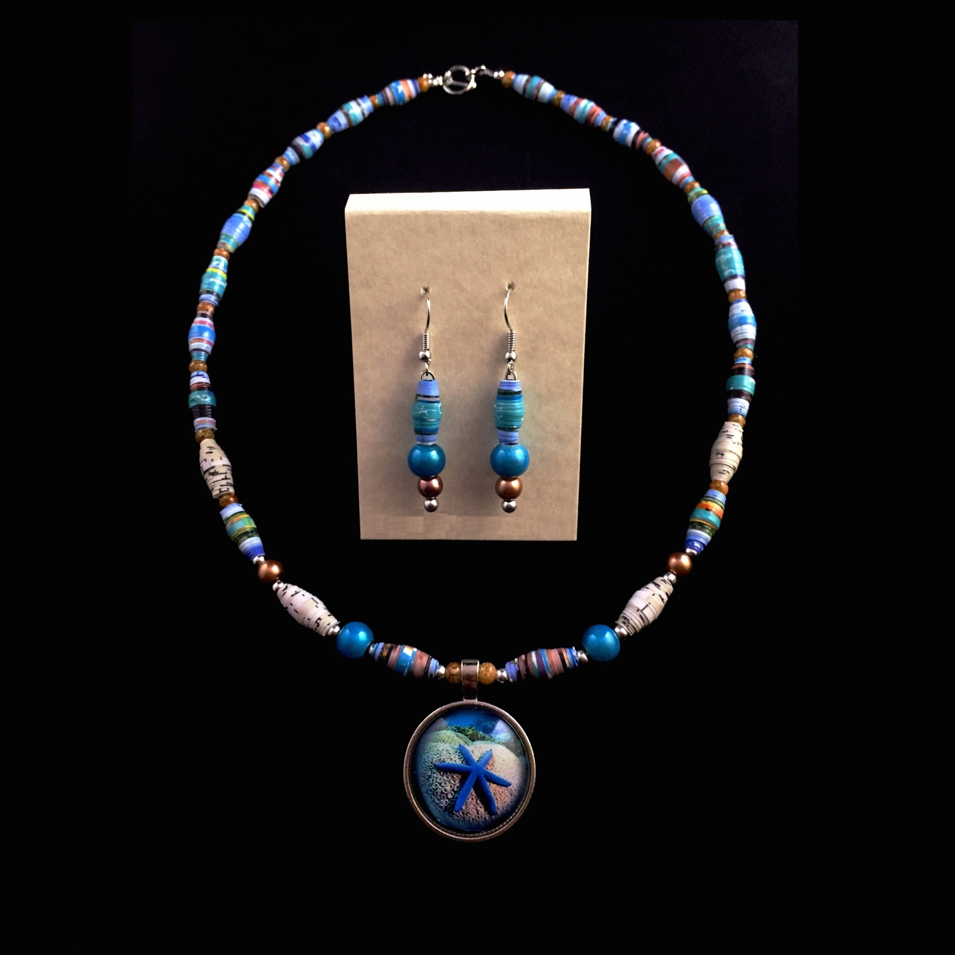Necklace and earring set that is a combination of blues and tans with a starfish on the pendant